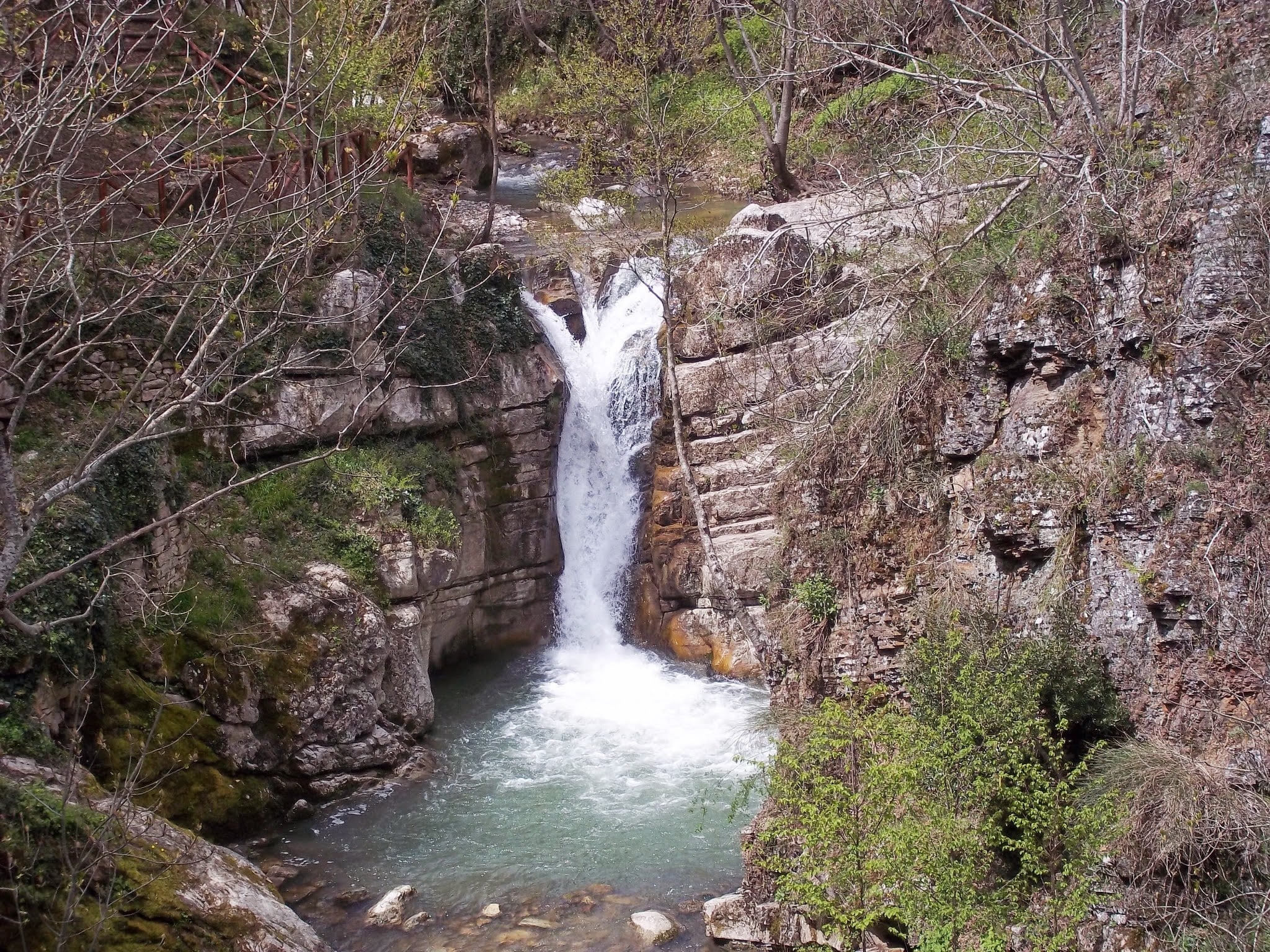 San Fele waterfall flowing through forest rocks